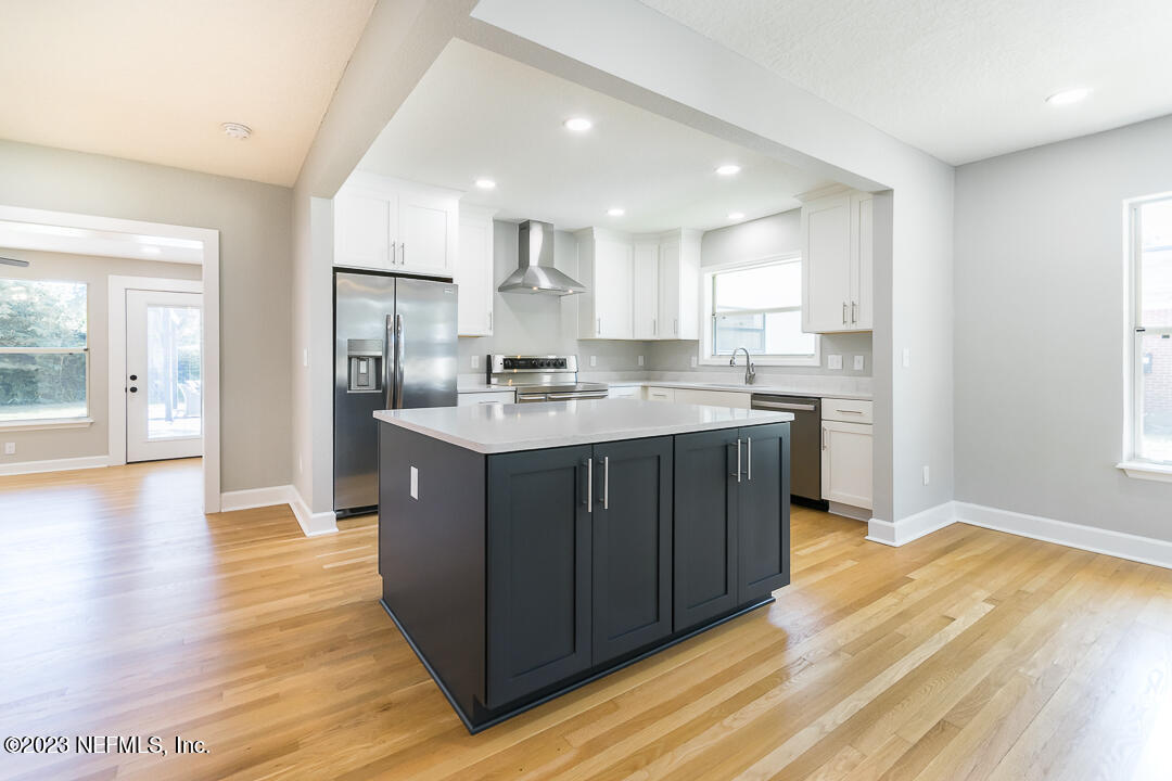 905 Waterman Road South Jacksonville, FL 32207 - Photo 3 of 19 a kitchen with stainless steel appliances granite countertop a sink a stove a refrigerator cabinets and a wooden floor