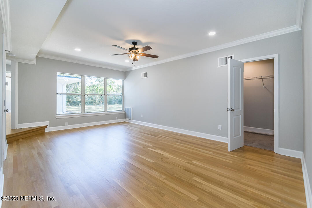 905 Waterman Road South Jacksonville, FL 32207 - Photo 5 of 19 wooden floor in an empty room with a window