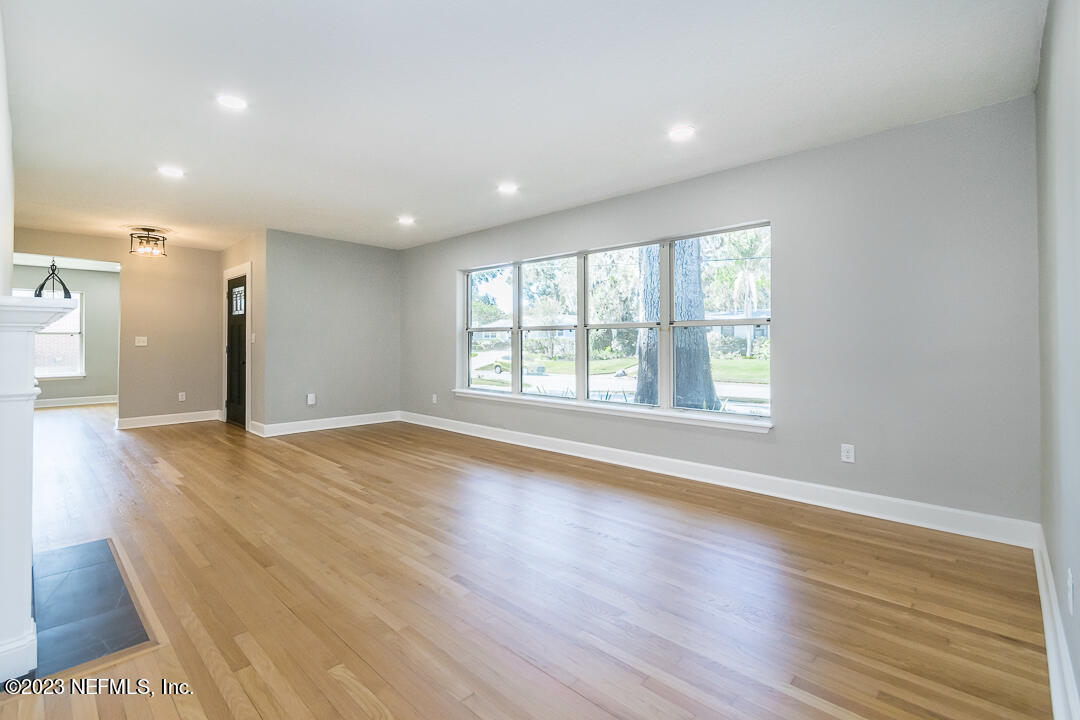 905 Waterman Road South Jacksonville, FL 32207 - Photo 10 of 19 an empty room with wooden floor and windows
