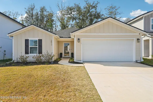a front view of house with yard and trees around