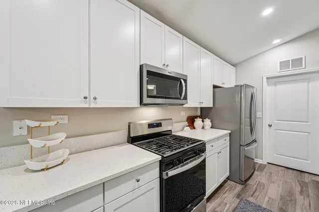 a kitchen with a sink a stove and refrigerator