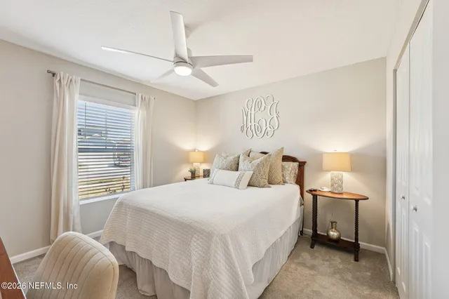 a bedroom with a bed and a window