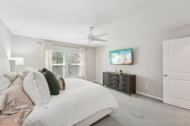 a bedroom with a large bed and a window