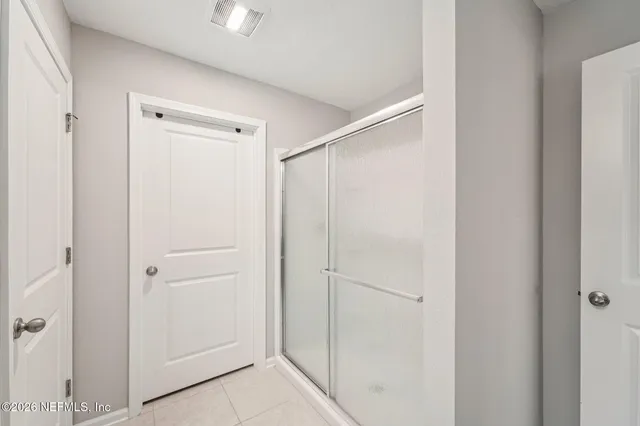 a bathroom with a shower and a door