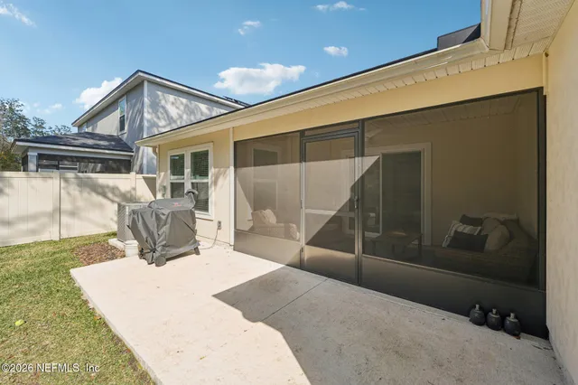 a view of a patio with table and chairs