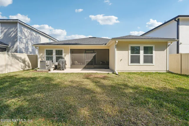 a view of a house with backyard and porch