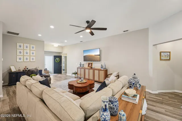 a living room with furniture and wooden floor