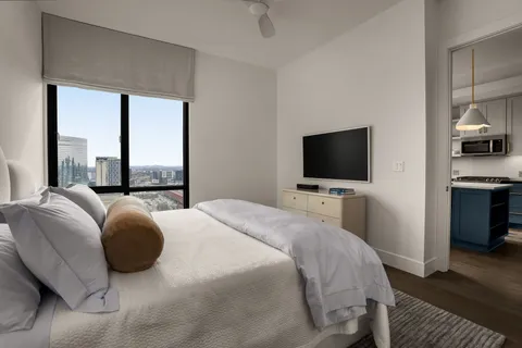 a bedroom with a bed and a flat screen tv