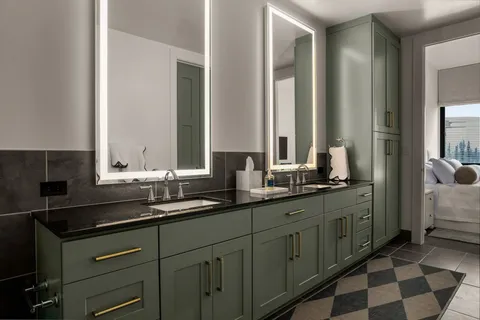 a bathroom with double sink and a mirror