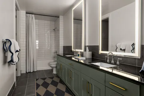 a bathroom with a double vanity sink and a mirror