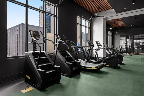 a room with gym equipment and a gym machine