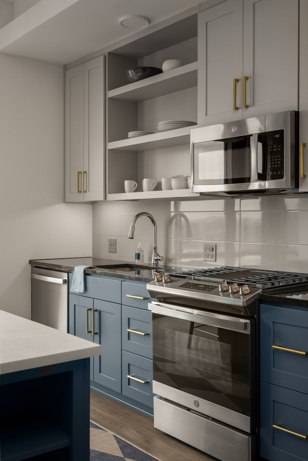 930 Commerce Street, Unit 30 Nashville, TN 37203 - Photo 5 of 45 a kitchen with stainless steel appliances granite countertop a stove and a microwave