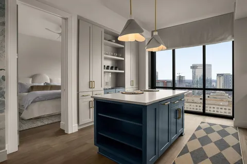 a kitchen with stainless steel appliances granite countertop a stove a sink and a refrigerator