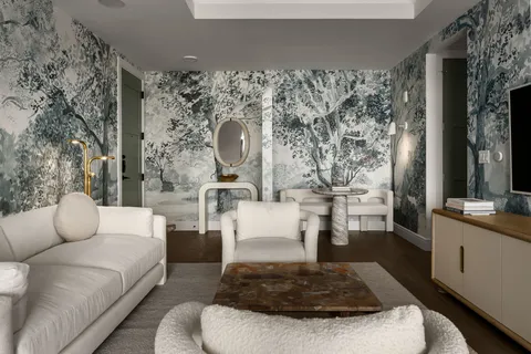 a living room with furniture and a large mirror