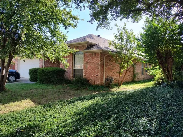a view of a house with a yard and plants