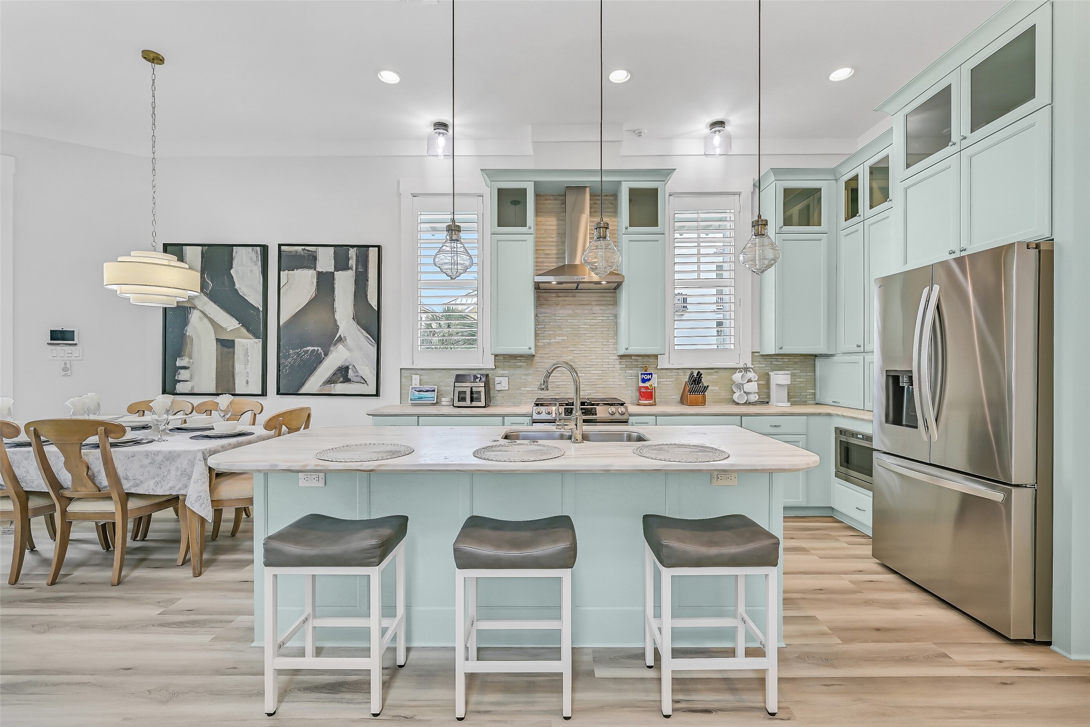 817 Positano Road Galveston, TX 77550 - Photo 3 of 50 The chef-inspired kitchen showcases granite countertops, gas cooking, custom cabinetry, and a spacious island designed for gathering. Recent upgrades include enhanced ventilation above the stove, refreshed finishes, and new beach-inspired flooring that creates a brighter, more modern coastal atmosphere. Whether preparing dinner or entertaining guests, this beautifully updated space blends style, functionality, and effortless beach-house charm.
