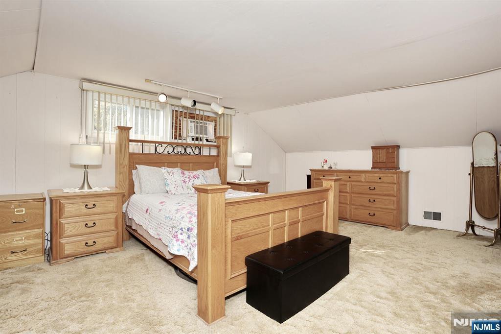 40 Depew Street Dumont, NJ 07628 - Photo 19 of 38 a bed room with a bed and a chair