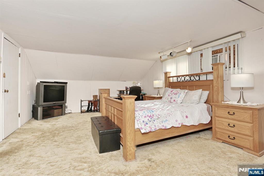 40 Depew Street Dumont, NJ 07628 - Photo 20 of 38 a bedroom with furniture and a flat screen tv