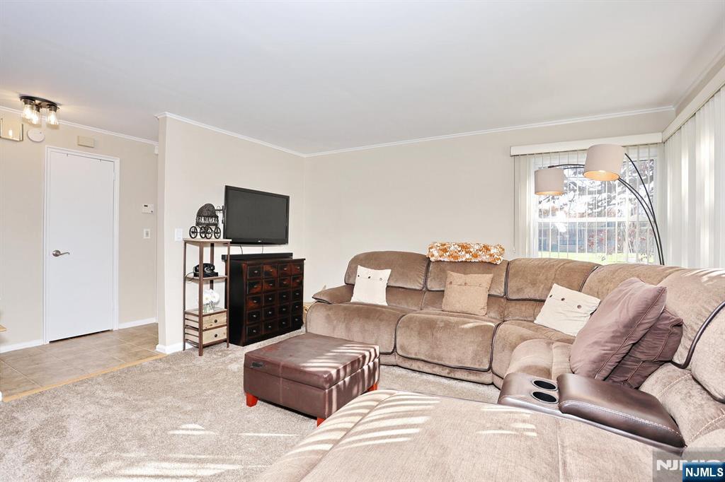 40 Depew Street Dumont, NJ 07628 - Photo 4 of 38 a living room with furniture a large window and a flat screen tv