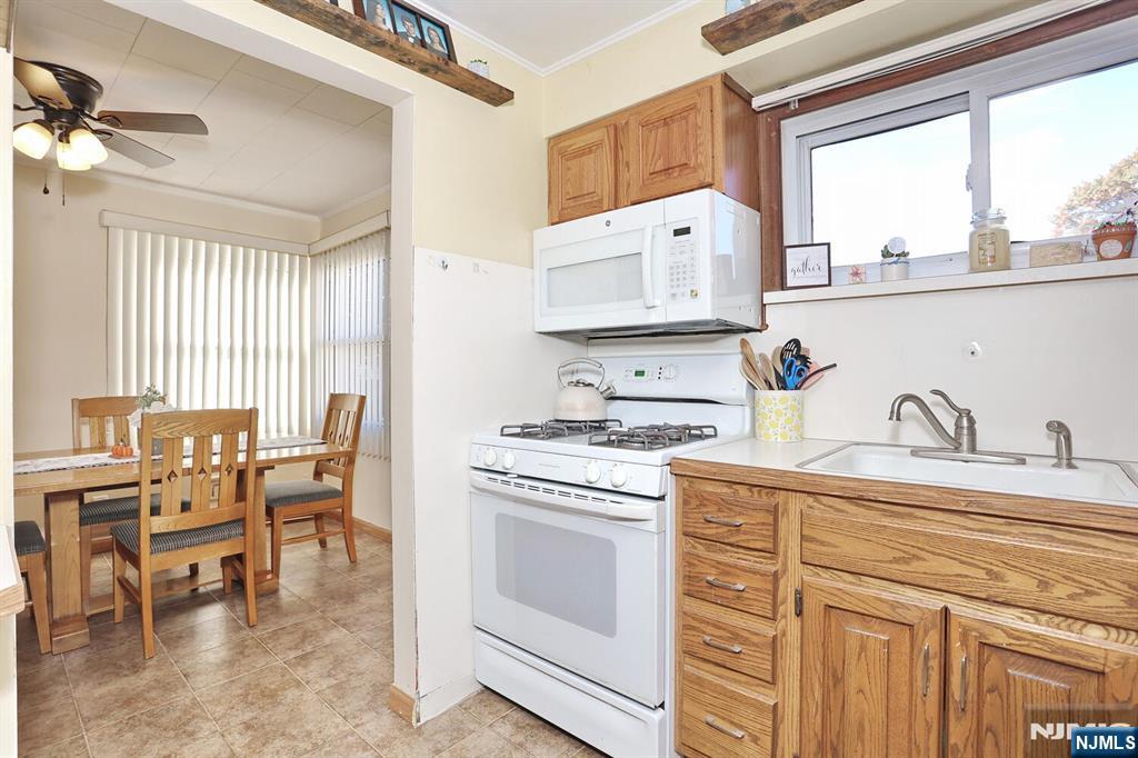 40 Depew Street Dumont, NJ 07628 - Photo 10 of 38 a kitchen with a stove a sink and cabinets