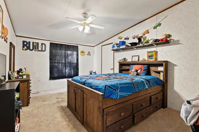 a bedroom with bed and wooden furniture
