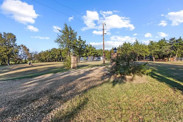 a view of a yard with yellow lighting