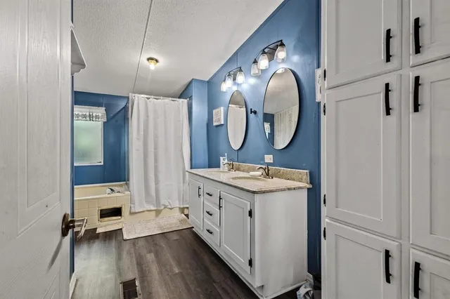 a bathroom with a toilet a sink and a mirror