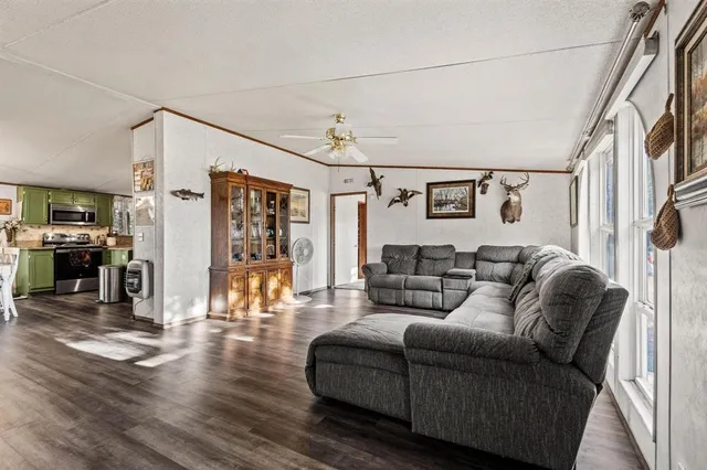 a living room with furniture and wooden floor