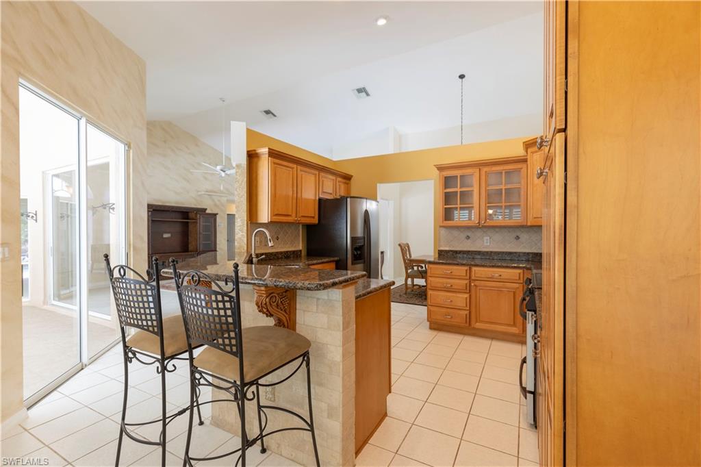 2100 Piccadilly Circus Naples, FL 34112 - Photo 11 of 30 a kitchen with stainless steel appliances a stove a refrigerator a kitchen island a stove and a refrigerator