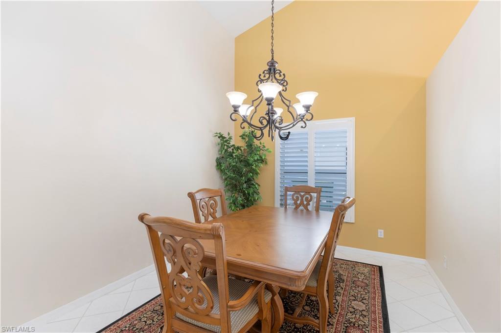 2100 Piccadilly Circus Naples, FL 34112 - Photo 12 of 30 a view of a dining room with furniture and chandelier