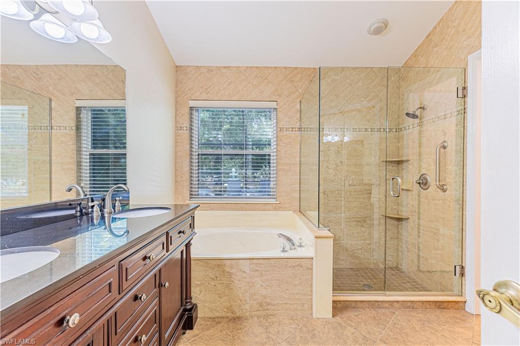 2100 Piccadilly Circus Naples, FL 34112 - Photo 18 of 30 a bathroom with a tub sink shower and mirror