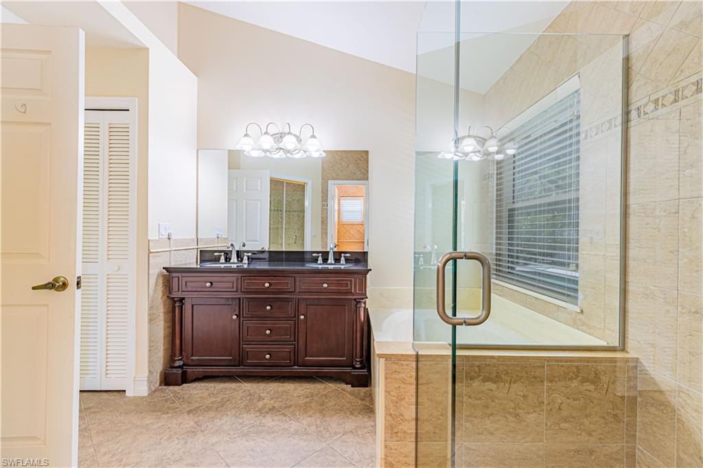 2100 Piccadilly Circus Naples, FL 34112 - Photo 19 of 30 a bathroom with a sink a mirror and a shower