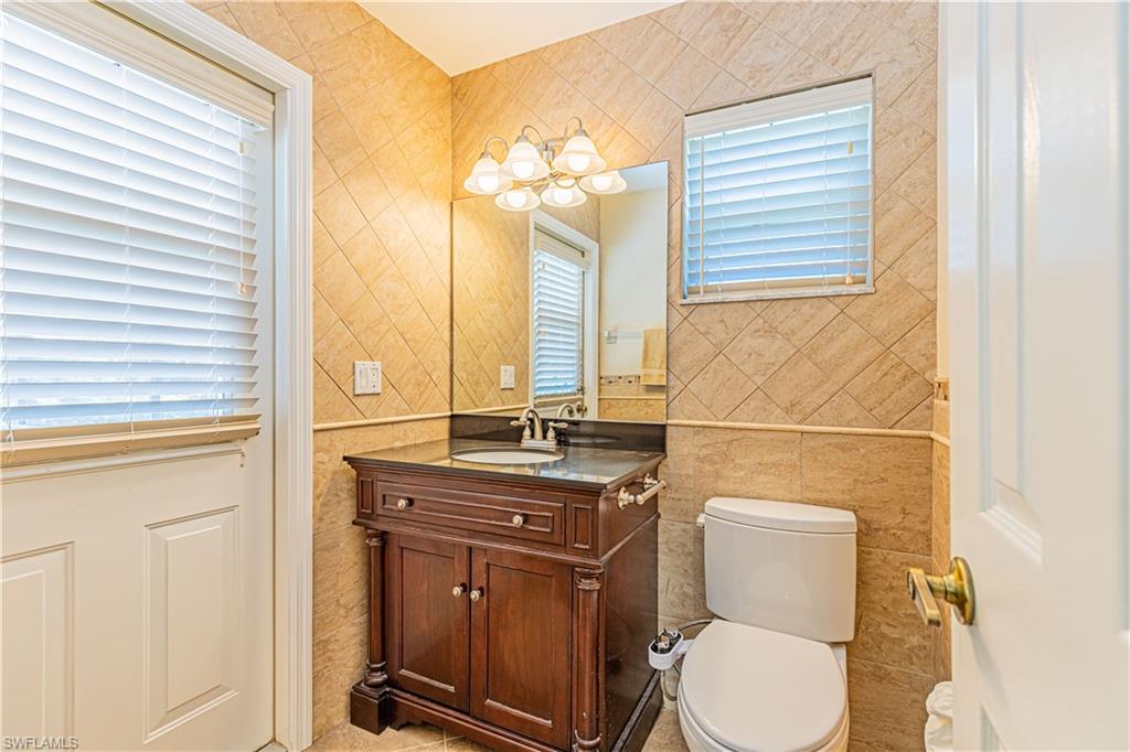 2100 Piccadilly Circus Naples, FL 34112 - Photo 20 of 30 a bathroom with a toilet a sink and a window
