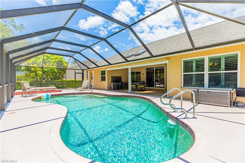 2100 Piccadilly Circus Naples, FL 34112 - Photo 2 of 30 a view of a swimming pool with a patio and a yard