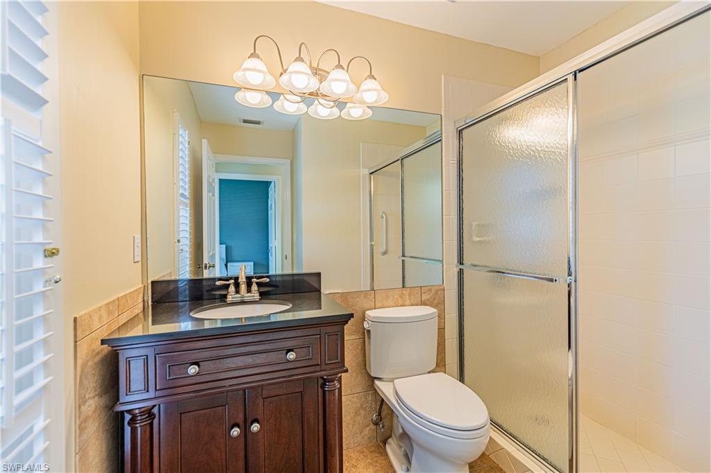 2100 Piccadilly Circus Naples, FL 34112 - Photo 22 of 30 a bathroom with a toilet sink and mirror