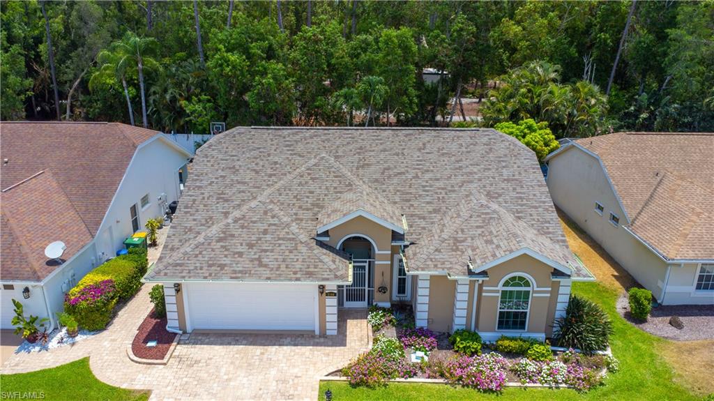 2100 Piccadilly Circus Naples, FL 34112 - Photo 26 of 30 a front view of a house with a yard