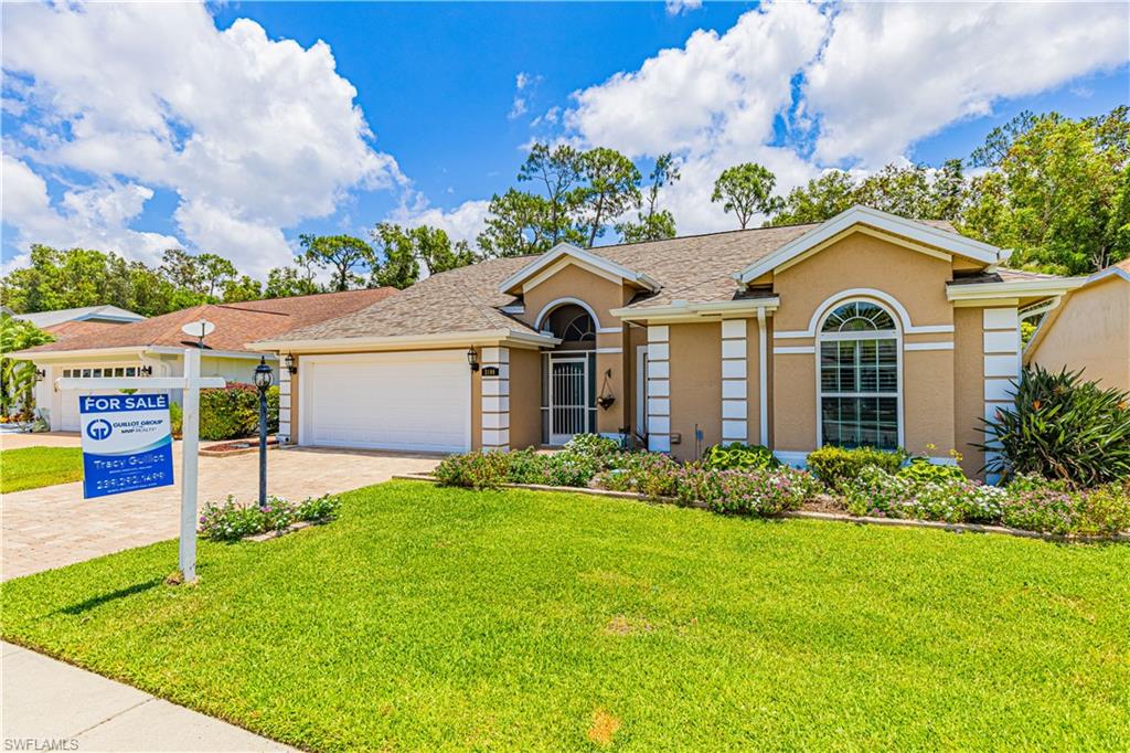 2100 Piccadilly Circus Naples, FL 34112 - Photo 30 of 30 a front view of a house with a garden and trees