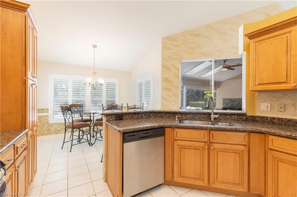 2100 Piccadilly Circus Naples, FL 34112 - Photo 8 of 30 a kitchen with granite countertop sink cabinets and dining table