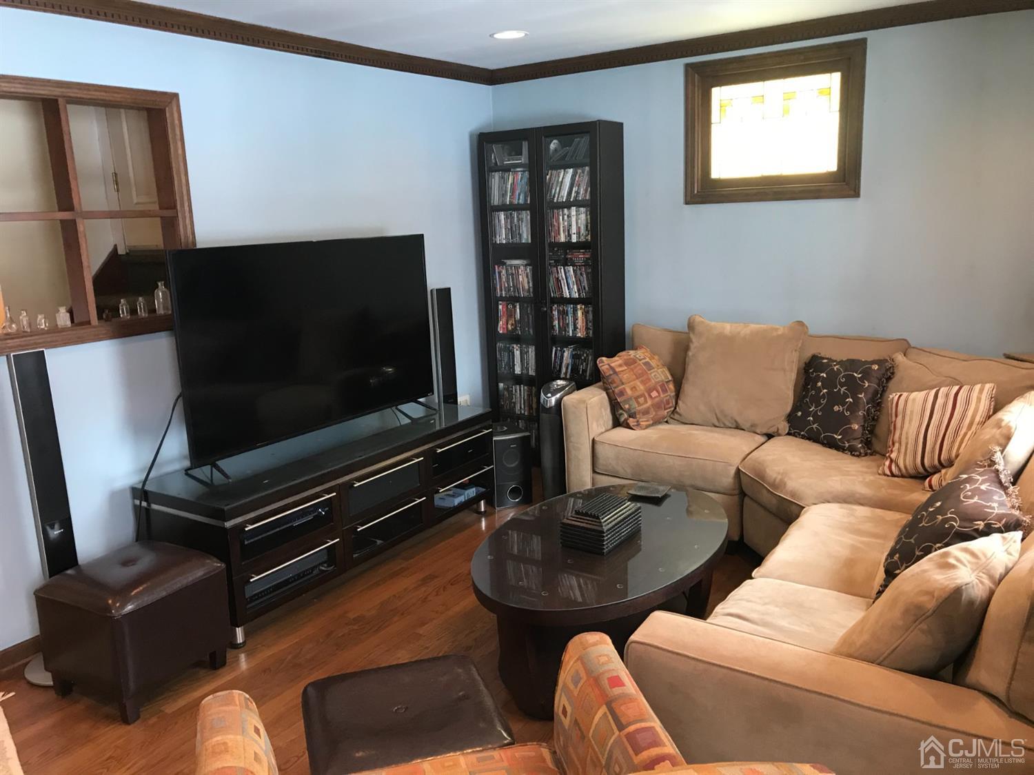 10 Wilcox Road New Brunswick, NJ 08901 - Photo 2 of 41 a living room with furniture and a flat screen tv