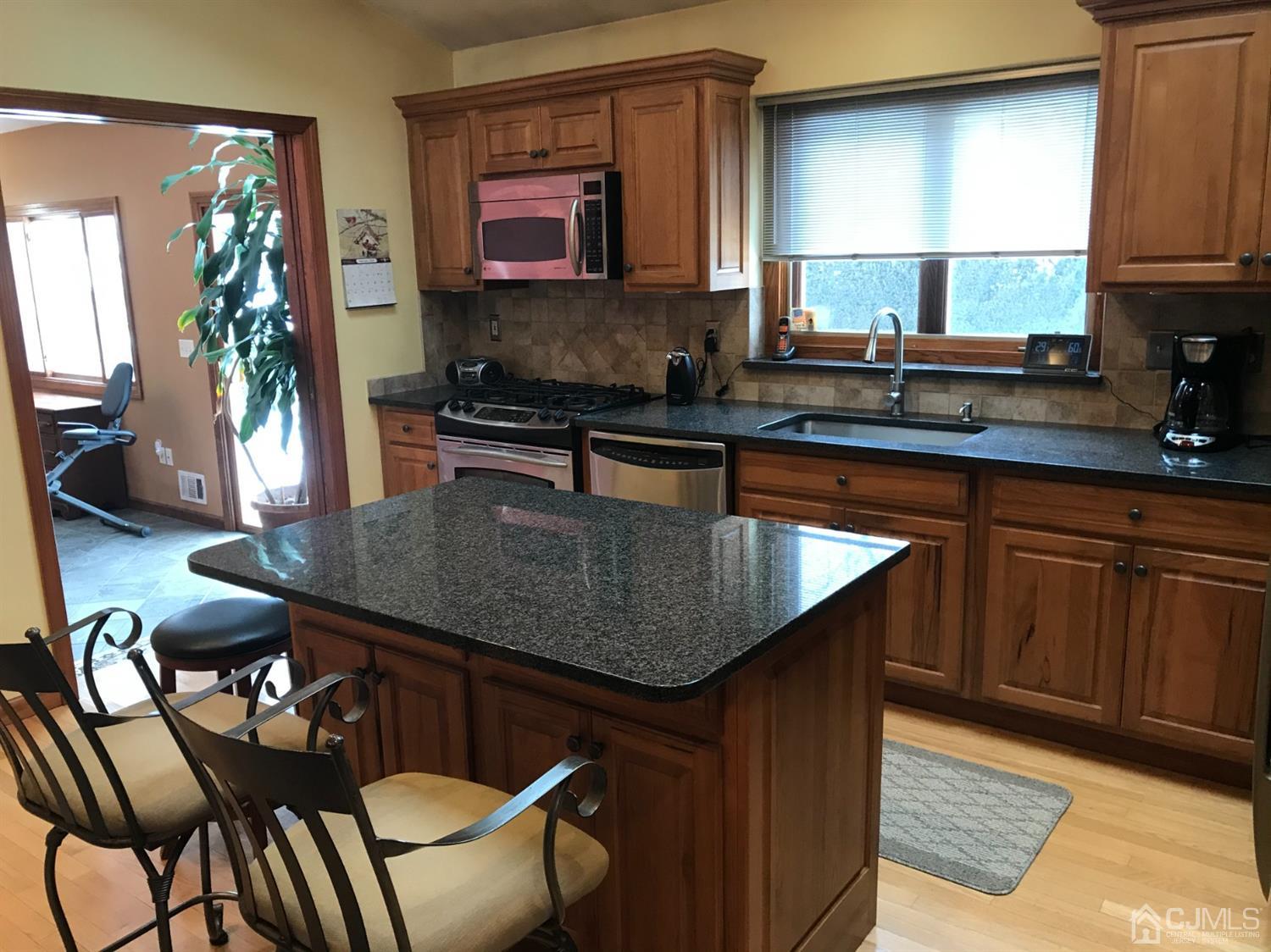 10 Wilcox Road New Brunswick, NJ 08901 - Photo 20 of 41 a kitchen with a table chairs sink and cabinets