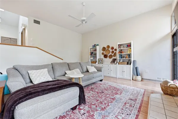 a spacious bedroom with a bed a couch and a window