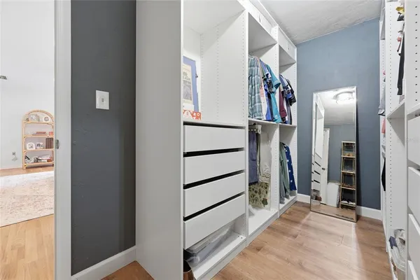 a view of walk in closet with windows