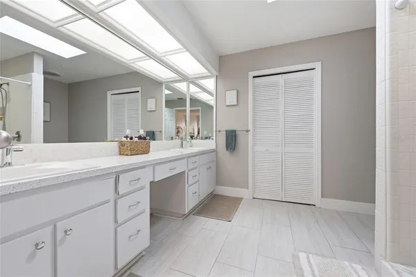 a spacious bathroom with a shower sink and mirror