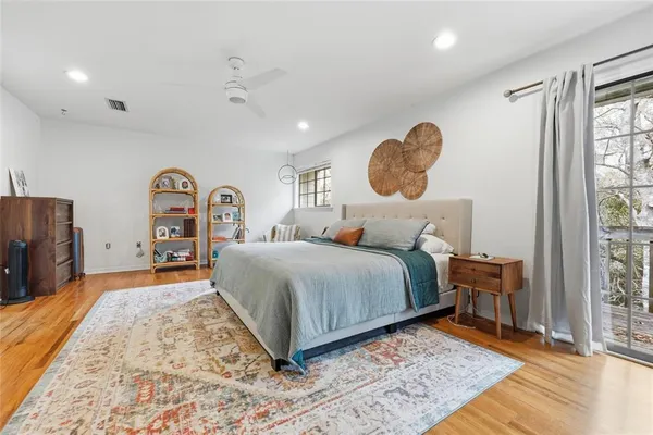 a bedroom with a large bed and a window