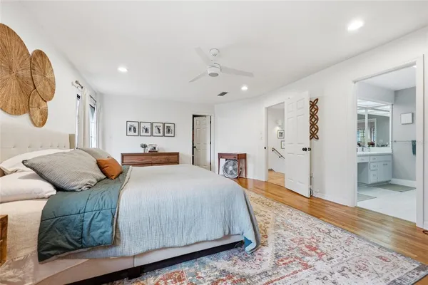 a bedroom with a large bed and a chandelier
