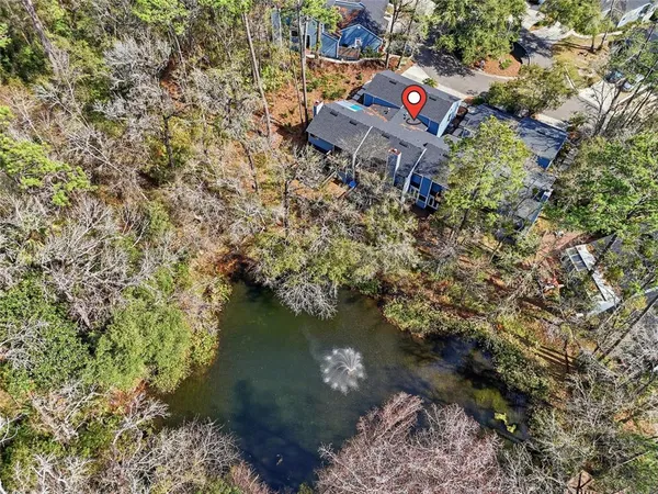 an aerial view of a house with a yard and lake view