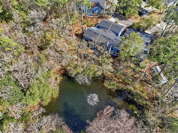 an aerial view of a house with a yard and lake view