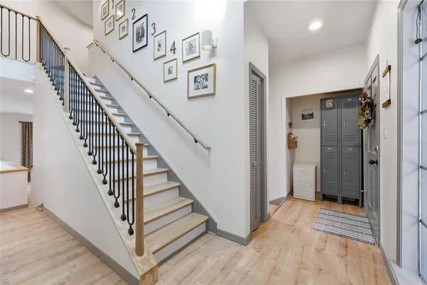 a view of a hallway with wooden floor and entryway
