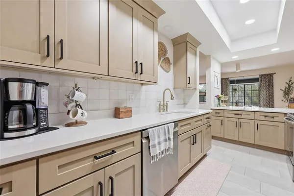 a kitchen with granite countertop white cabinets and white appliances