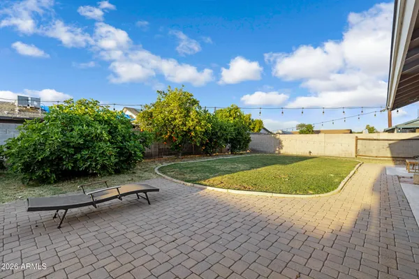 a view of a house with backyard and entertaining space